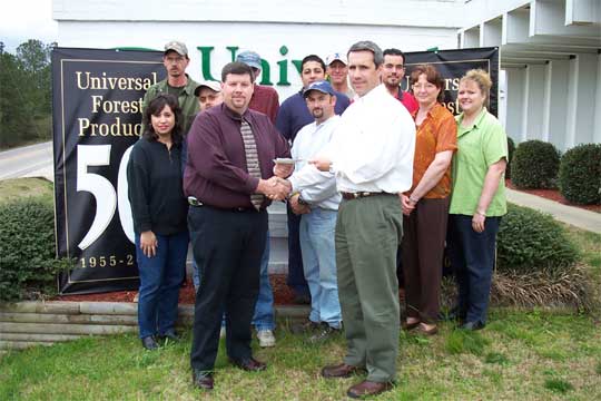 Rob Crook accepts a donation check to HfHMC from